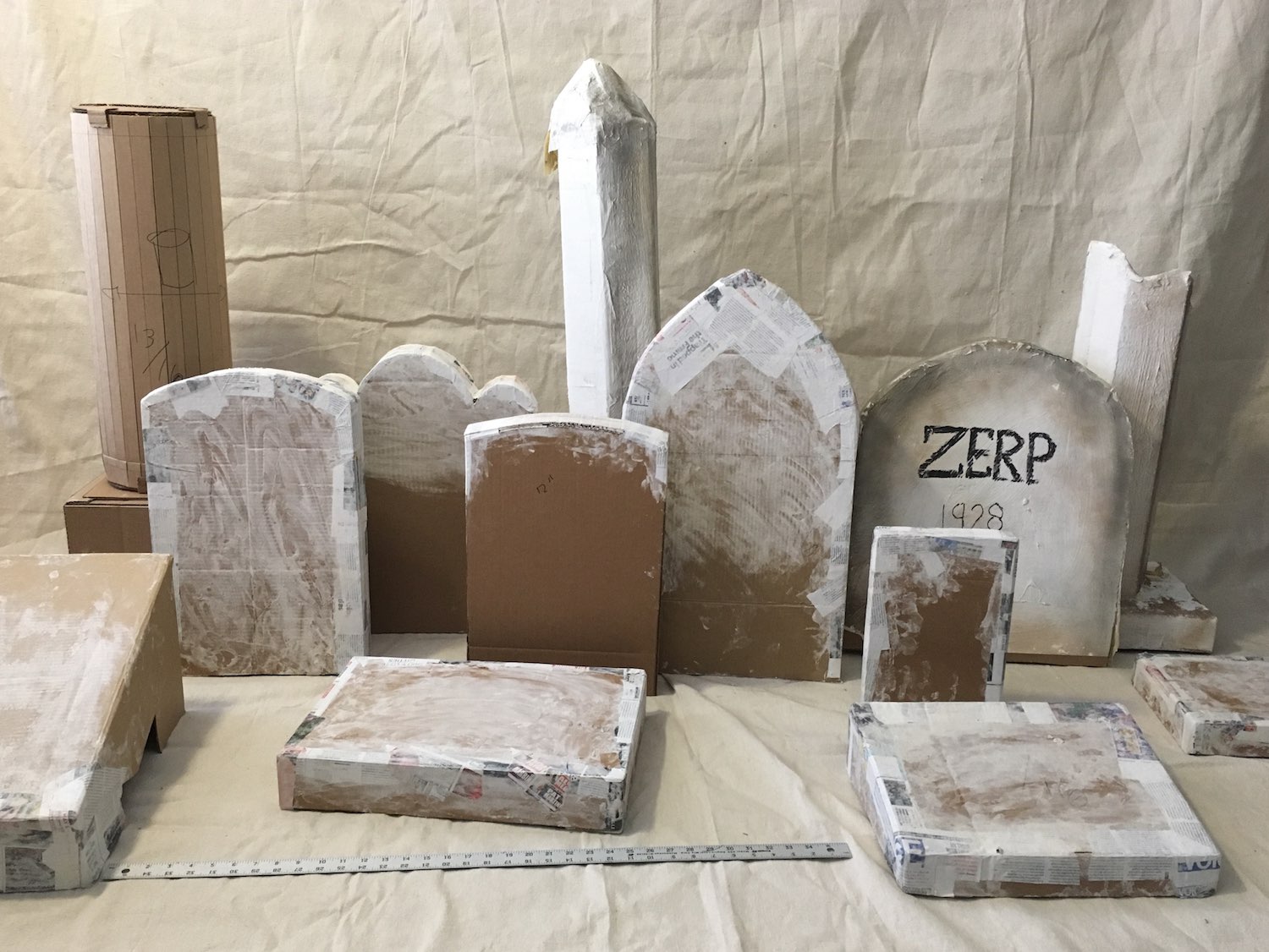 Cardboard and papier-mâché grave markers in progress