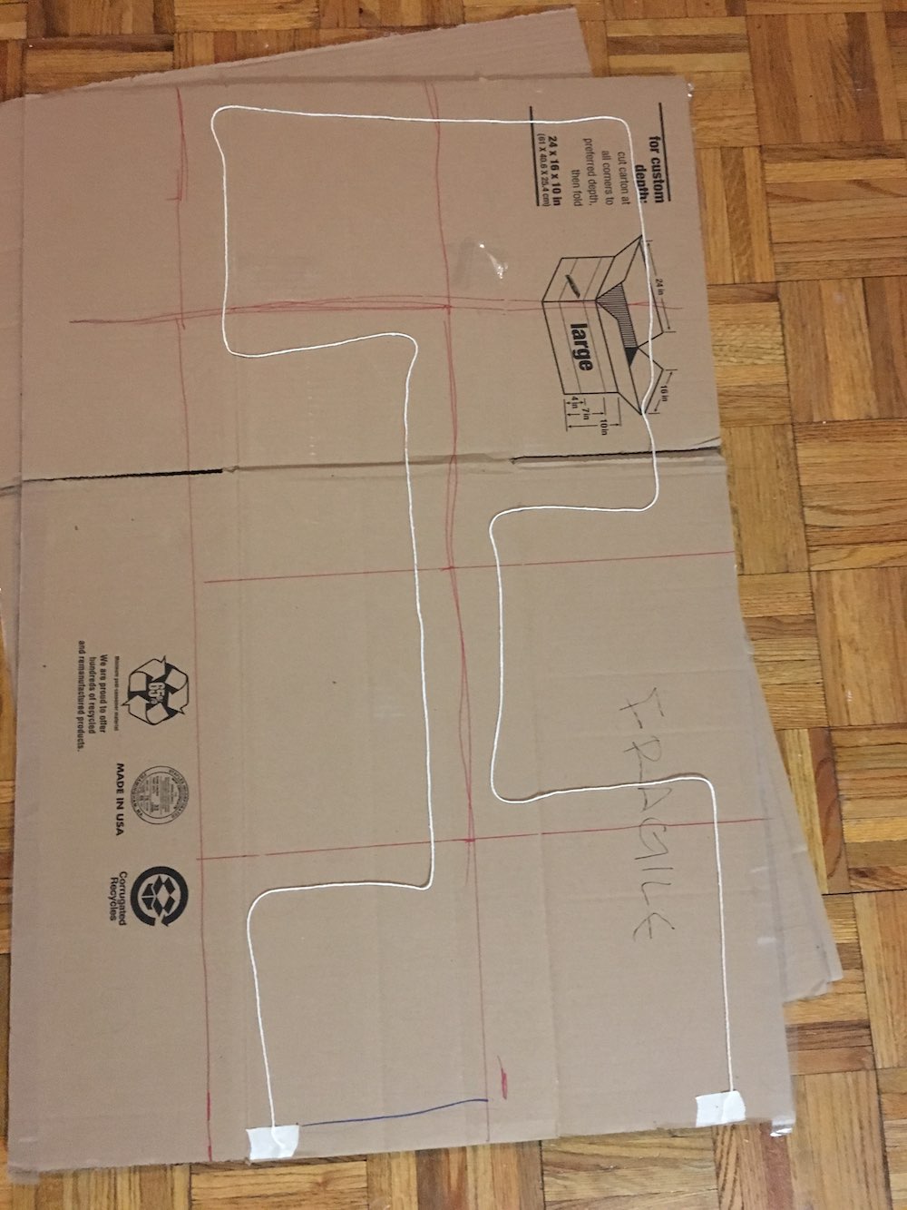 String laid out on cardboard in the shape of a path