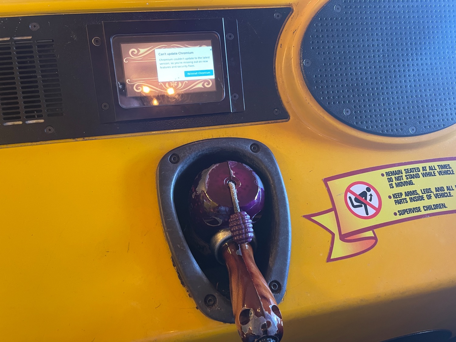 A small screen embedded in a theme park ride vehicle that is almost entirely obscured by a Chromium update error