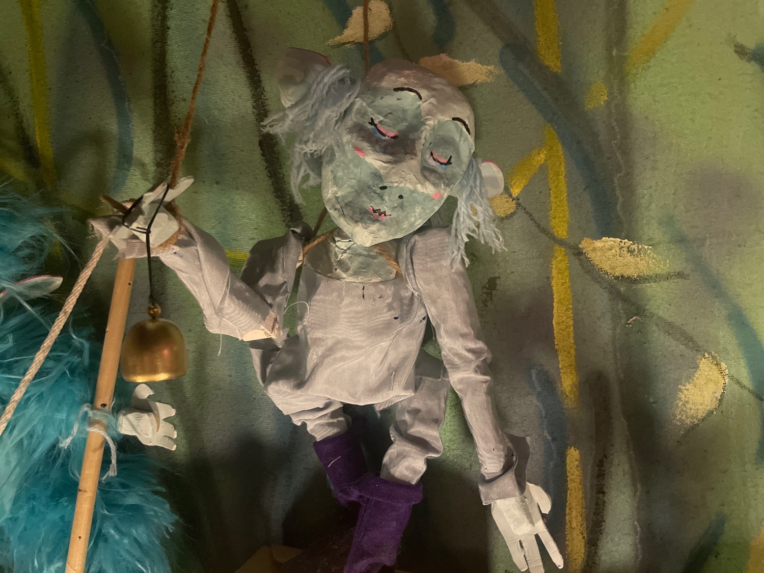 The bell ringer: prim, proper, proud, with tufts of hair a match dusty blue ensemble