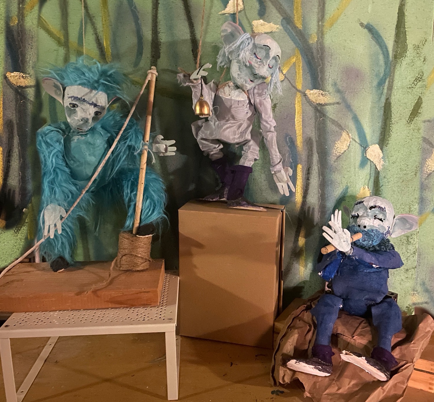 The trio, arranged in a facsimile of their eventual setting: standing at various elevations amid an impressionist jungle landscape
