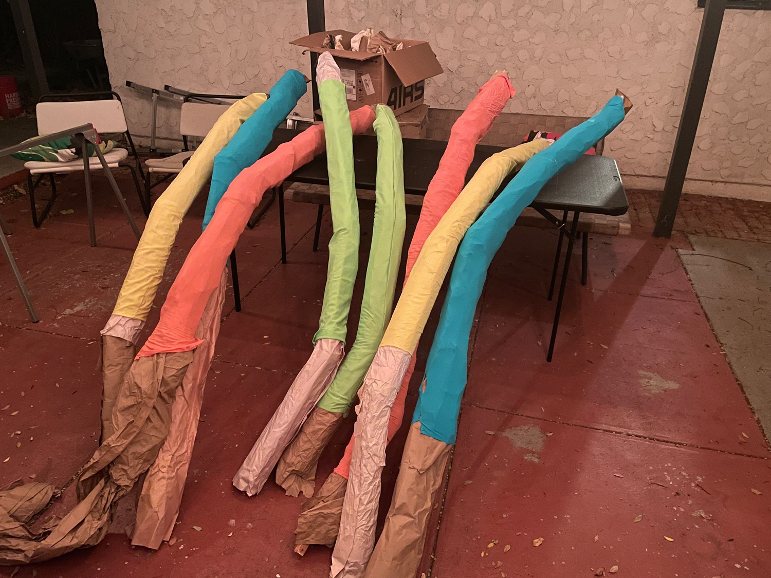 Half a dozen or so brightly-colored tubes leaning on a table in the yard.