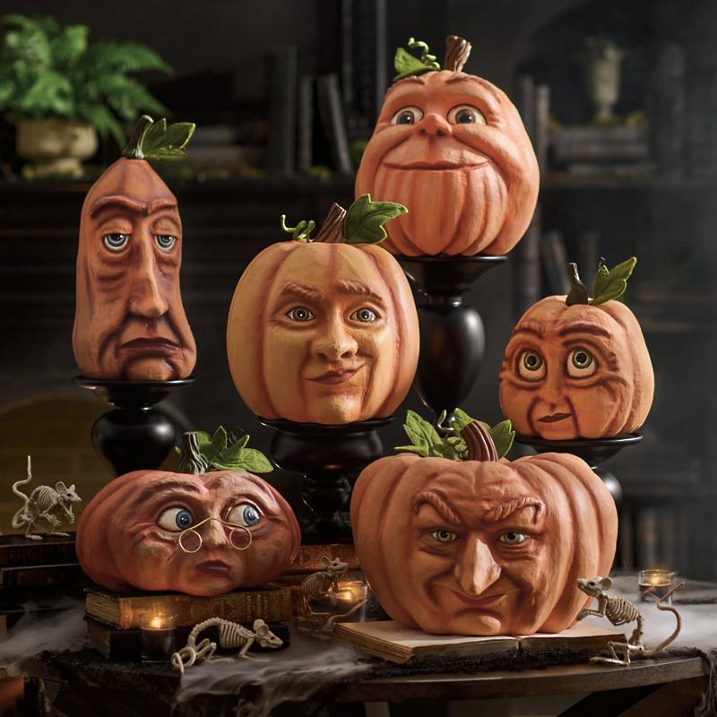 A collection of realistic pumpkin sculptures each with an exaggerated human-like face