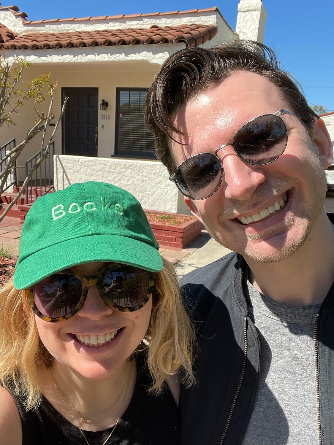 A selfie of me and Amy in front of our new house