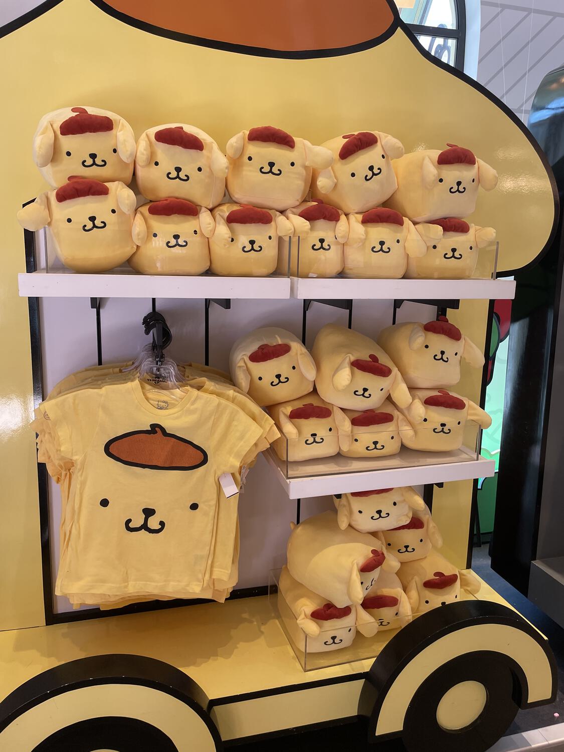 A display of products featuring a Sanrio character who is a dog with a beret