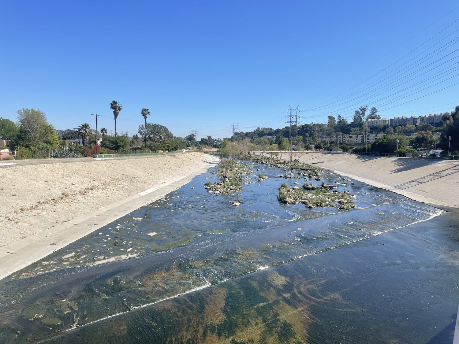 The LA river as seen from overhead, low water and sparse foliage