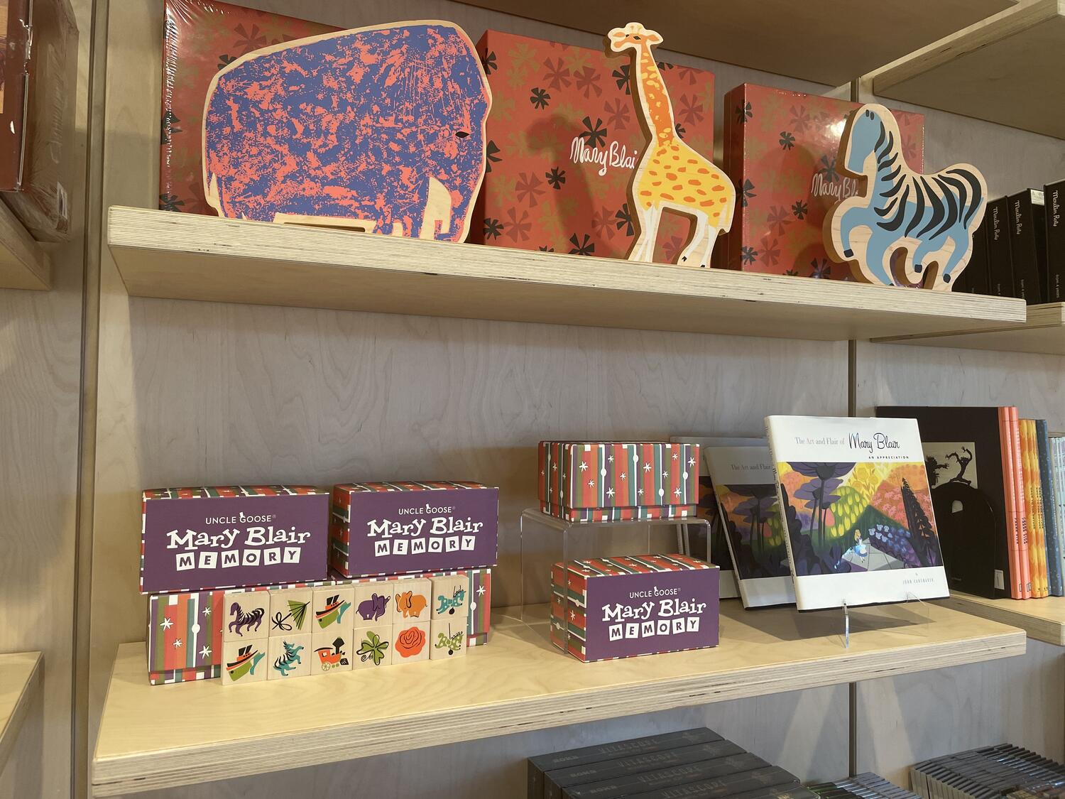 Mary Blair merchandise in the museum gift shop—art books, wooden tiles for a memory game, and cute abstract African animals as wooden cutouts