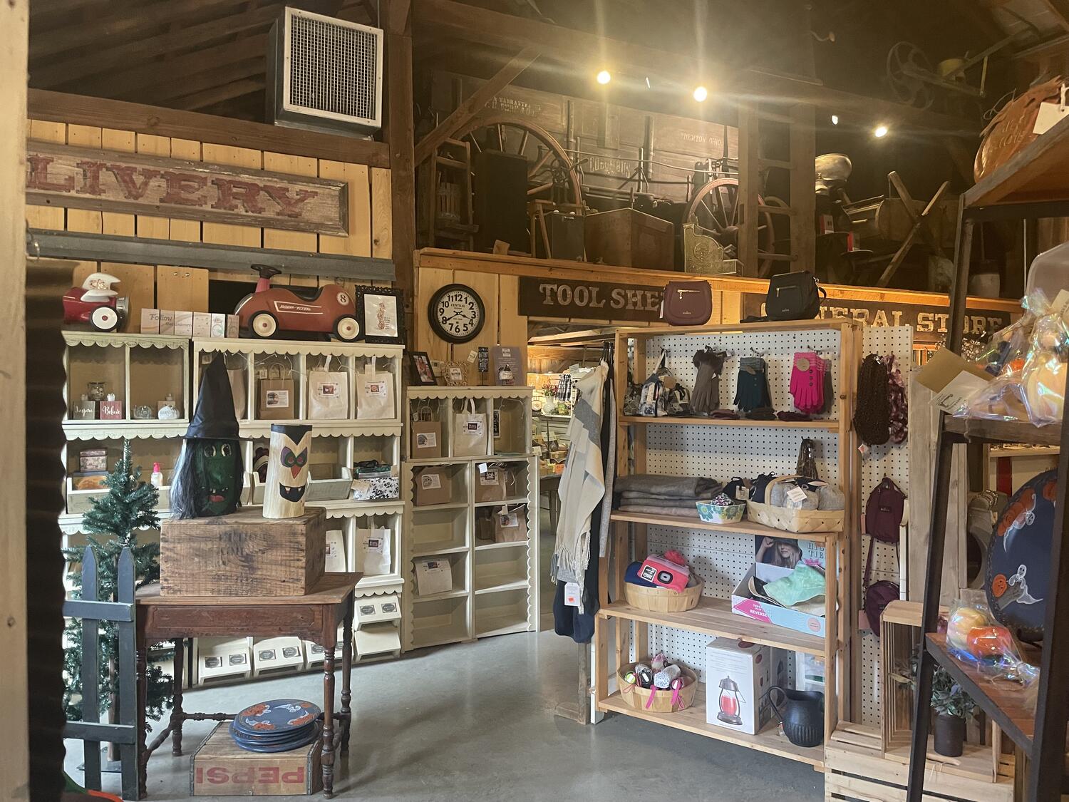 A busy little shop full of mostly handmade goods. The walls are bare rough wood, farm-style