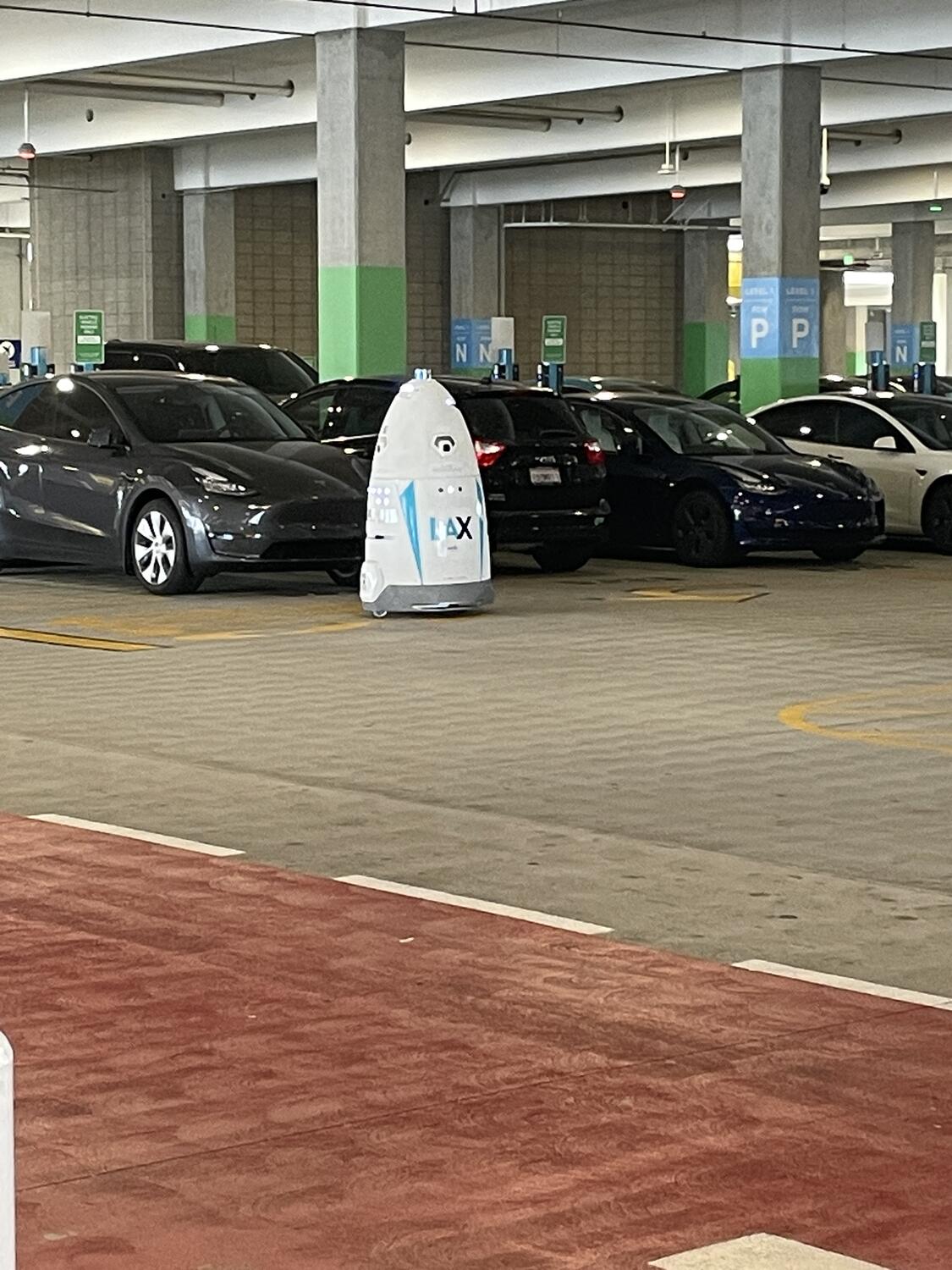 A roaming security robot in a parking lot