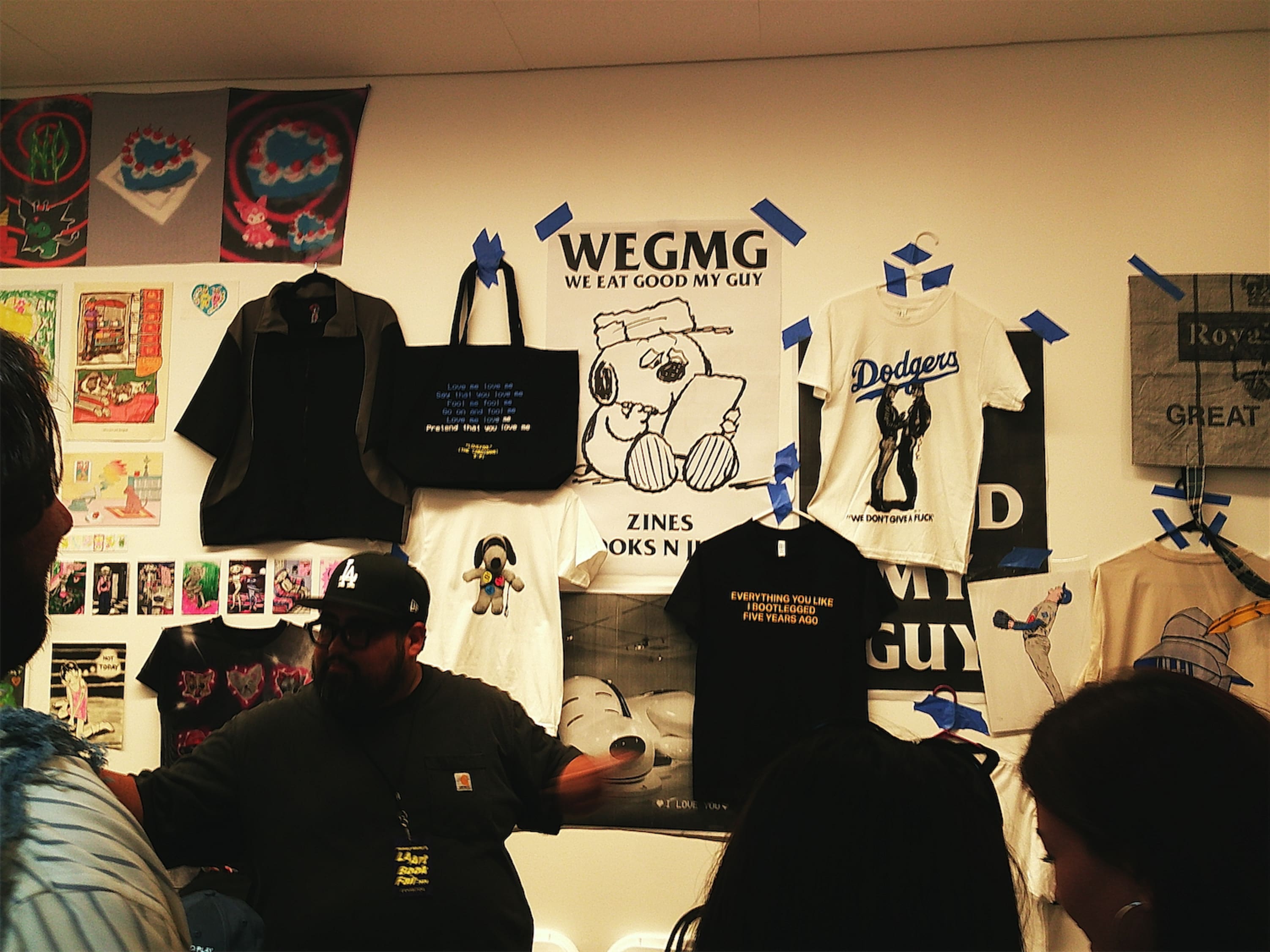 A rough DIY assortement of culture-clashing merch, including a tshirt with Snoopy's brother Mortimer that reads WE EAT GOOD MY GUY